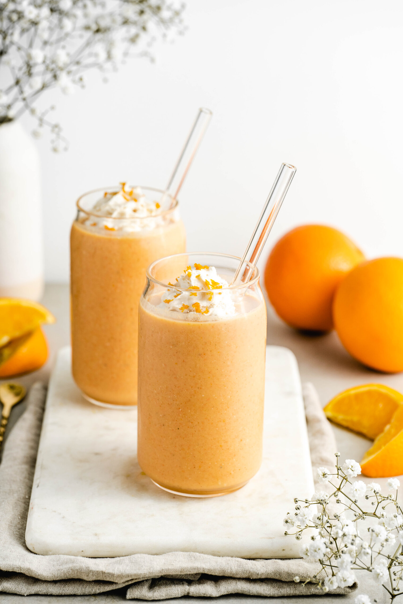 Orange Creamsicle Protein Shake with dairy free whipped topping and orange zest
