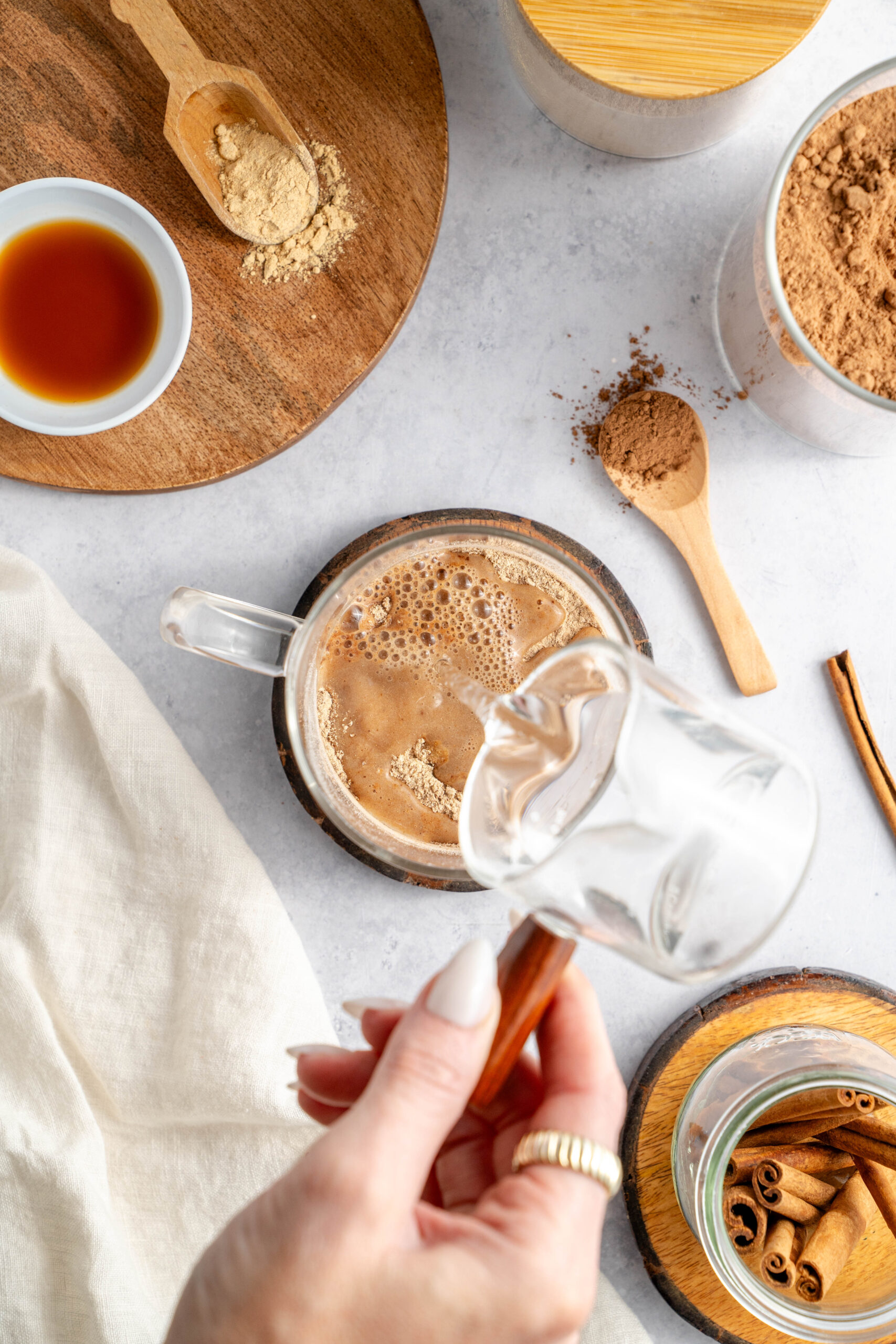 hot water being poured into ingredients to make maca latte