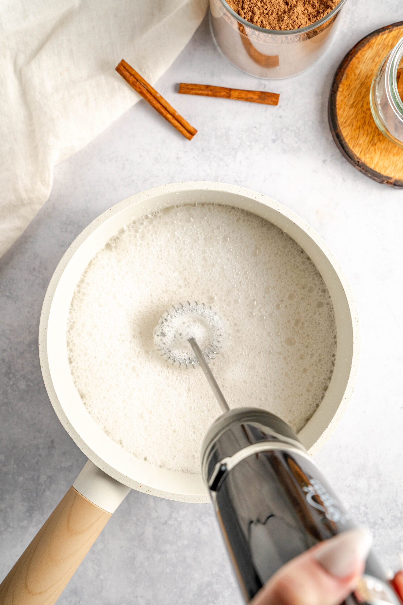 milk in saucepan being frothed
