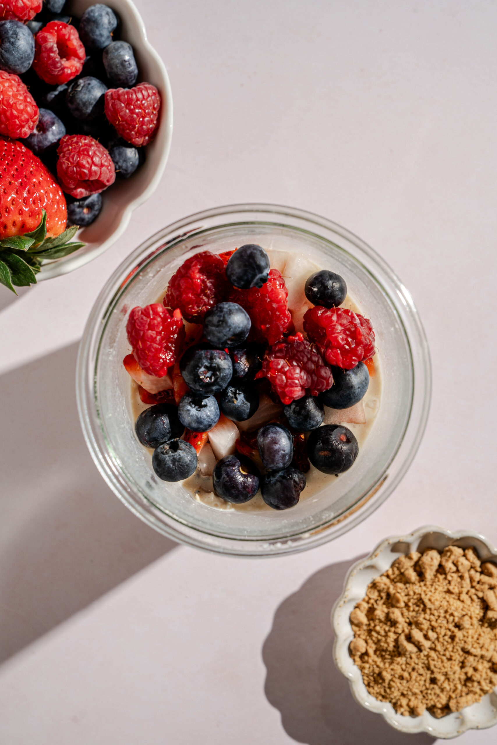adding berries to overnight oats to be mixed in